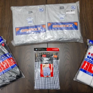 Packaged clothing and socks on wooden surface.