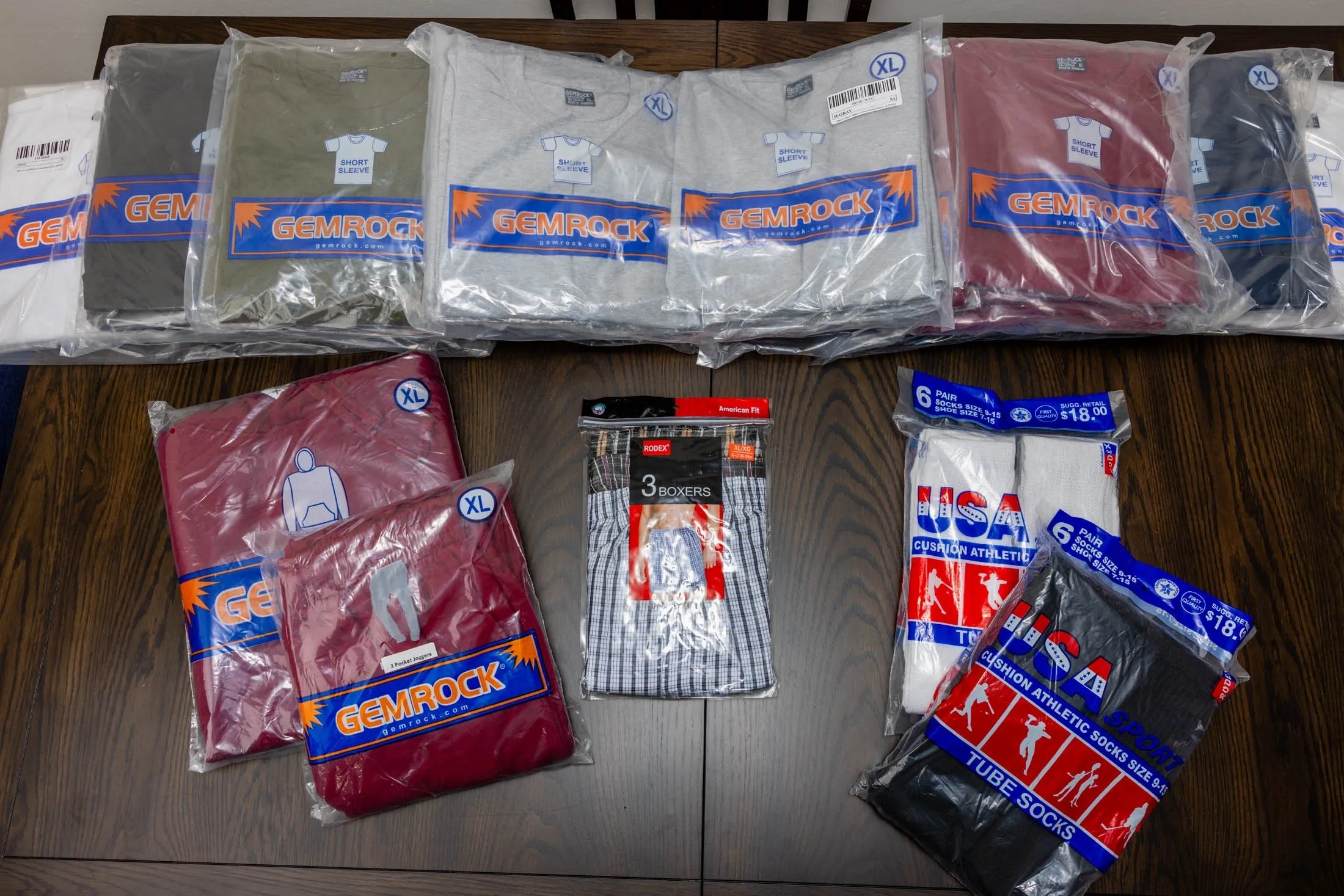 Assorted shirts and socks in packaging