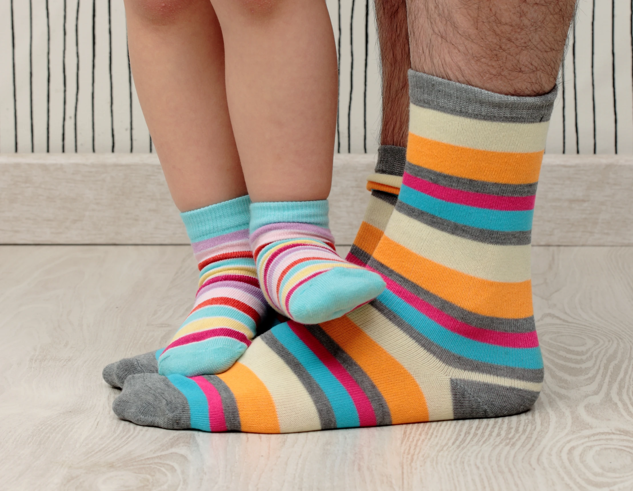 Matching striped socks on wood floor