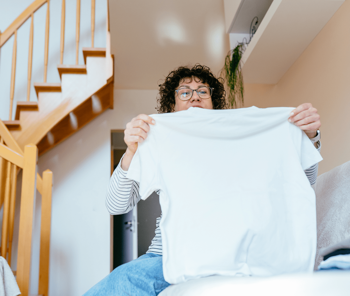 Individual displaying a plain white t-shirt